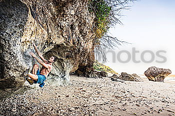 Similar – Young rock climber woman climbing the rock wall