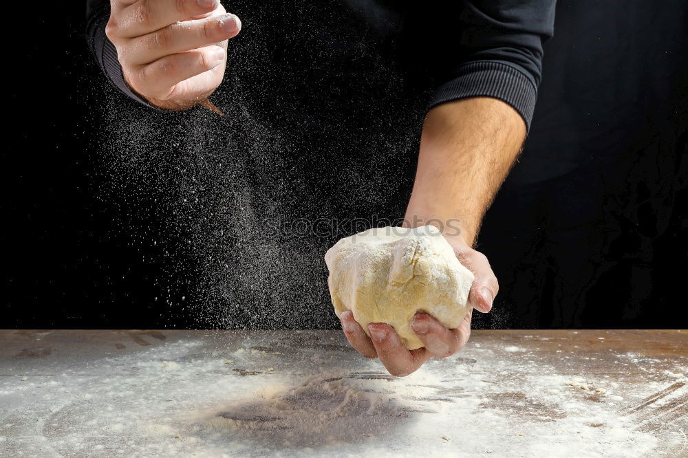 Similar – man sifts white wheat flour through a wooden sieve