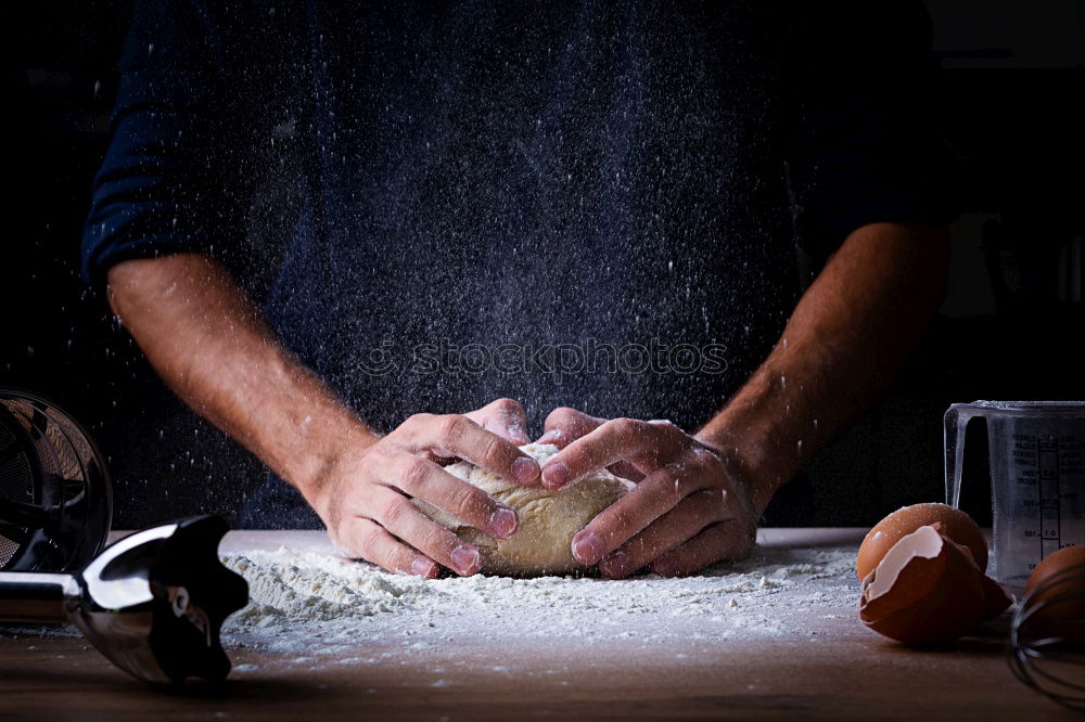 Similar – man sifts white wheat flour through a wooden sieve