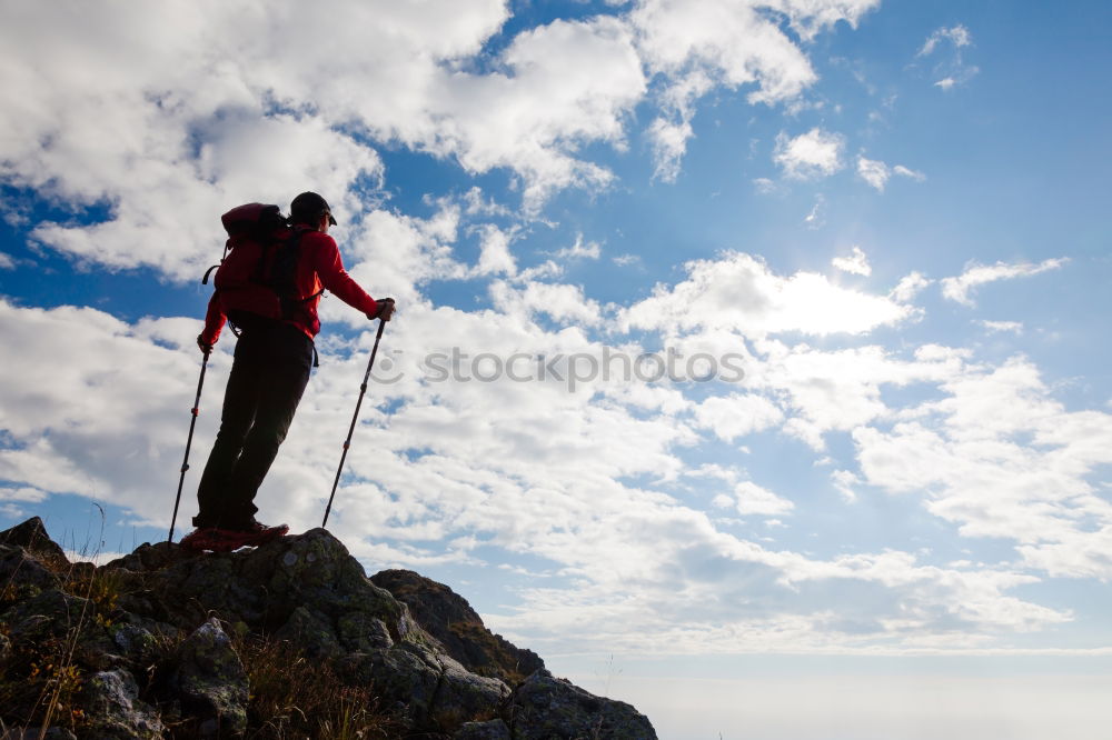 Male hiker standing on the top of a mountain.