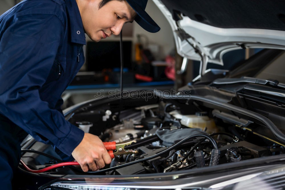 Similar – Professional Mechanic Repairing Car.