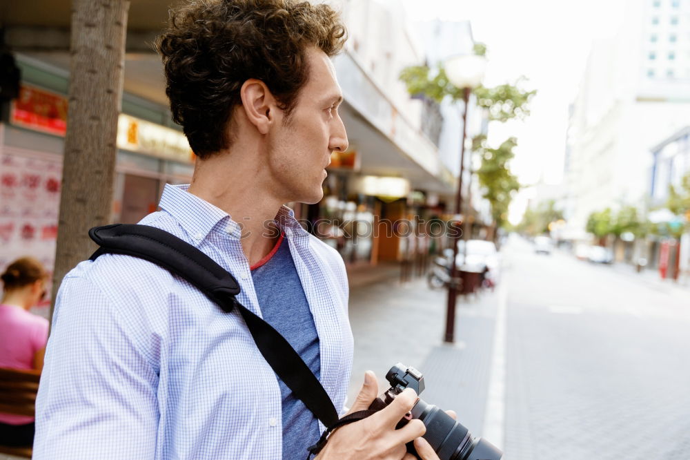 Similar – Traveler using smartphone on city