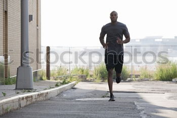 Similar – Image, Stock Photo Black man running upstairs outdoors listening to music with white headphones.