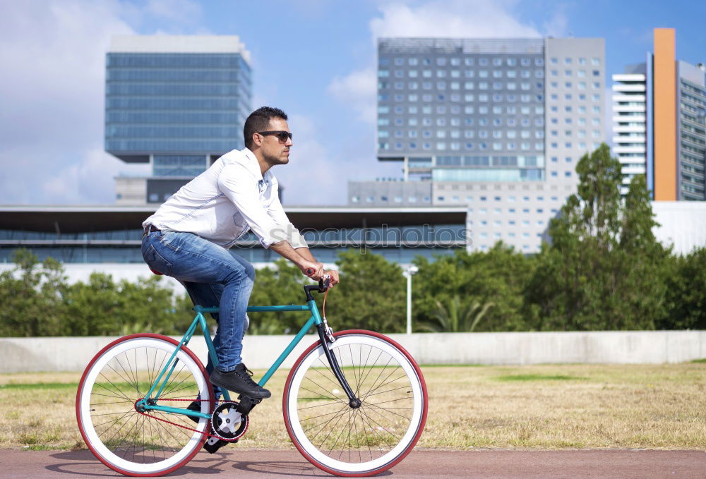 Image, Stock Photo Young man posing with bike on pavement