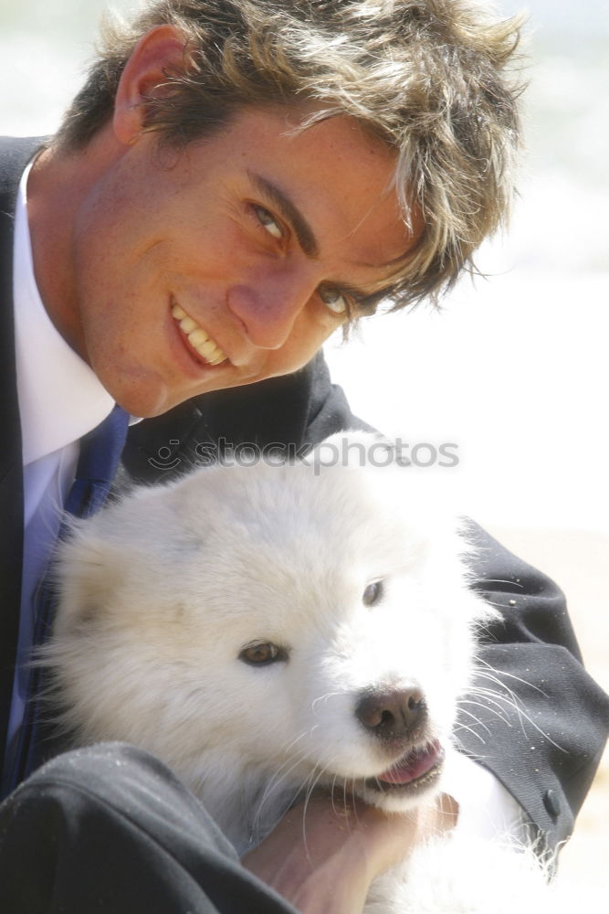 Similar – Image, Stock Photo Cute puppy licking face of young male adult