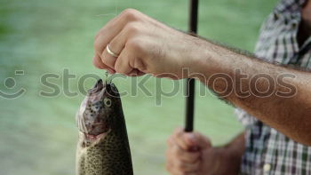 Similar – Fisherman caught a fish