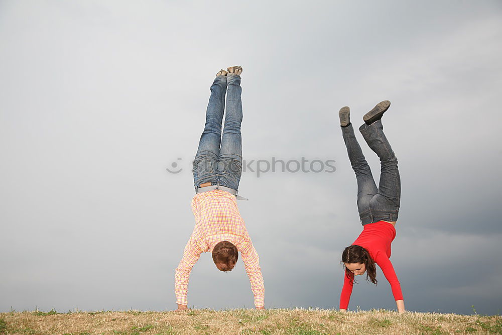 Similar – Young funny couple enjoying and doing a handstand