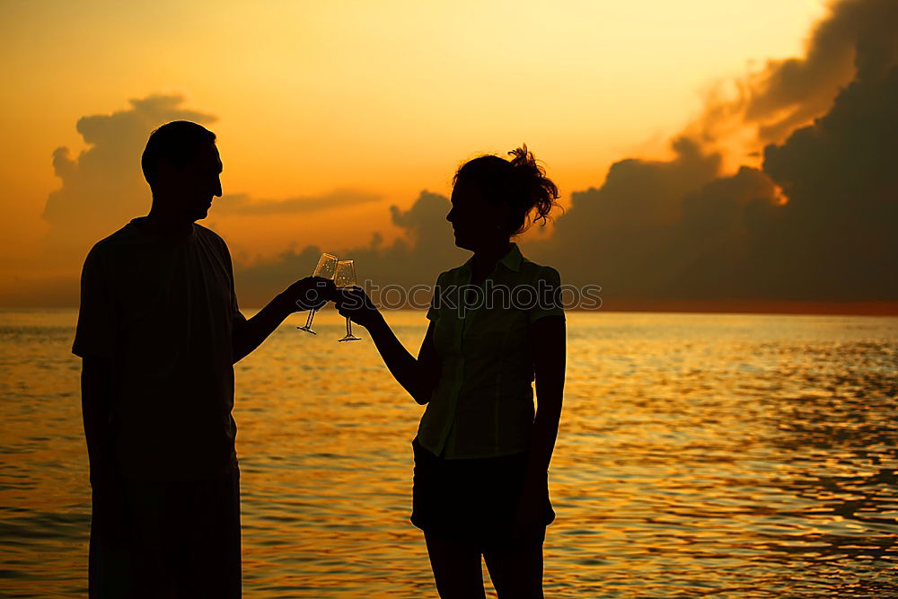 Similar – Mother and son holding hands on a beach at sunset