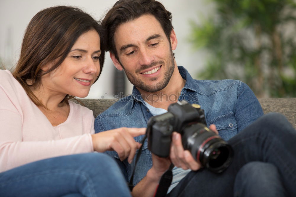 Similar – Young couple taking selfie photo with smartphone outdoors