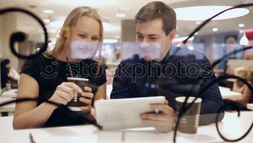 Similar – Image, Stock Photo Two teenagers in white sports shirts using tablet PC in cafeteria. They looking at pad screen