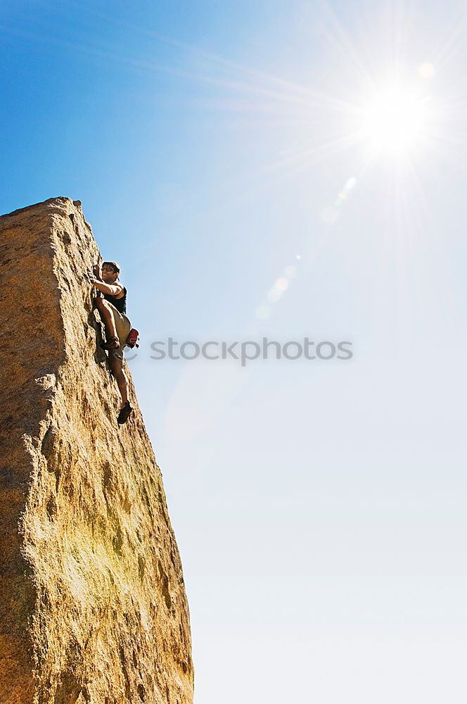 Similar – Image, Stock Photo Young couple rock climbing cliffs at the coast helping eachother