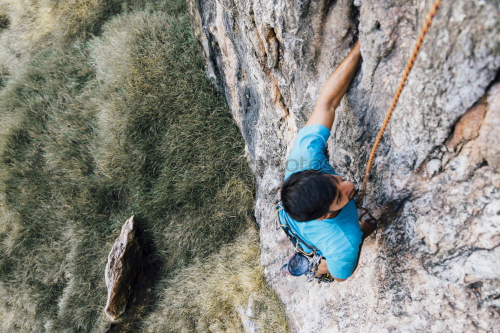 Similar – Young rock climber woman climbing the rock wall