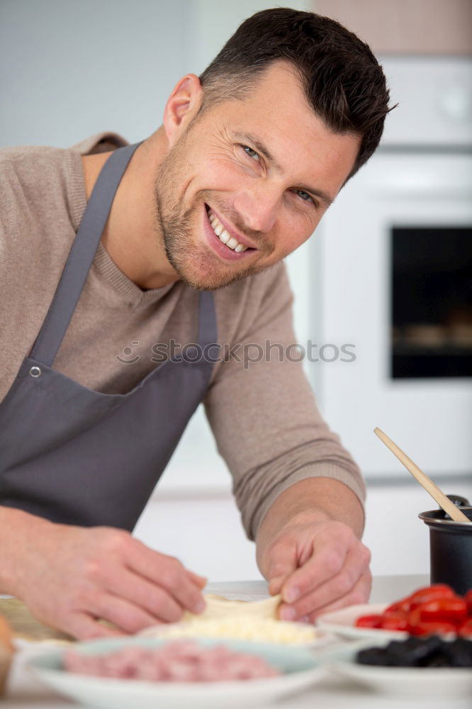 Similar – Young couple cooking. Man and woman in their kitchen