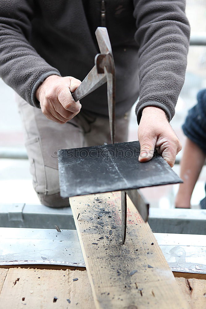 Similar – Carpenter cutting wooden board