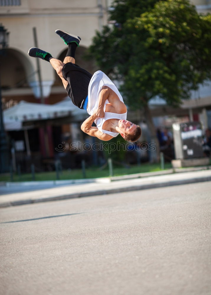 Similar – Motion shot of a young sportsman doing acrobatics in the city. Front flip trick