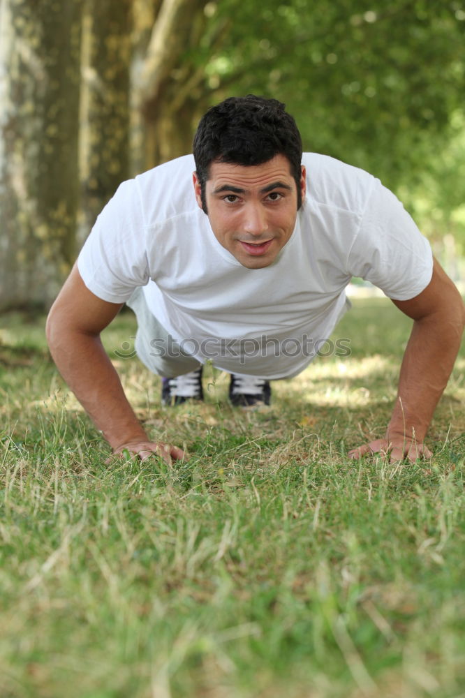 Similar – Fit shirtless young black man doing stretching after running