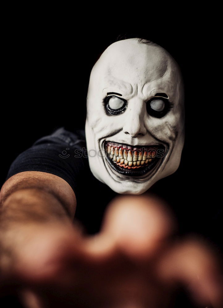 Similar – boy dressed as a clown on black background