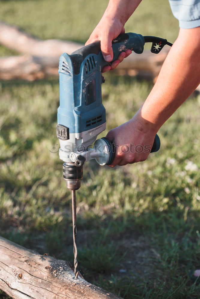 Similar – Image, Stock Photo Man drilling hole in timber while working in garden