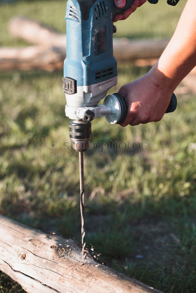 Image, Stock Photo Man drilling hole in timber while working in garden