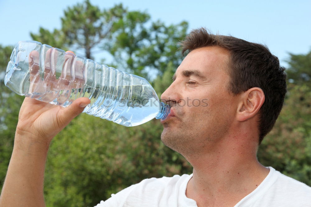 Similar – Fit young woman drinking bottled water