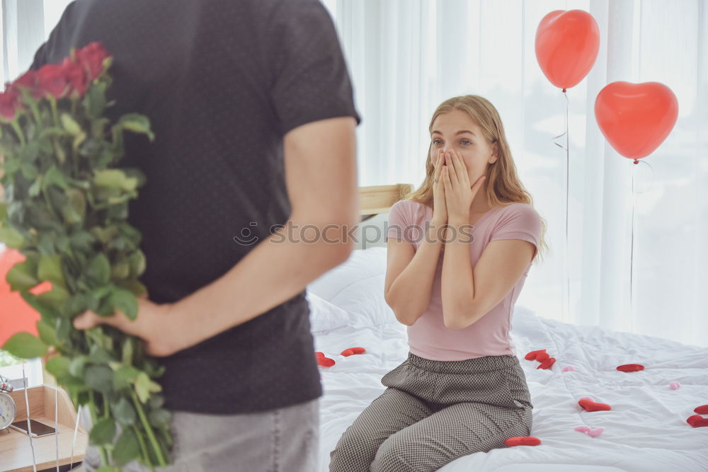 happy young couple in love surprising each other with gifts