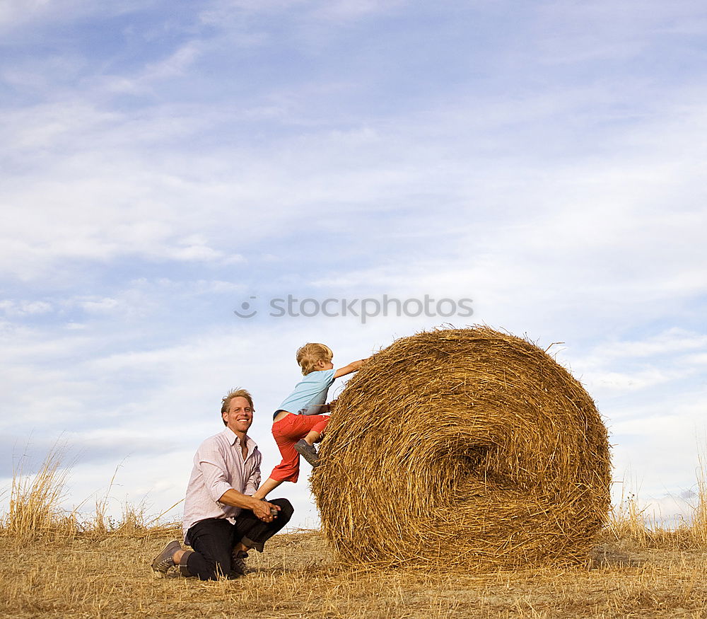 Similar – Brothers playing in the field.Children take pictures in the straw field