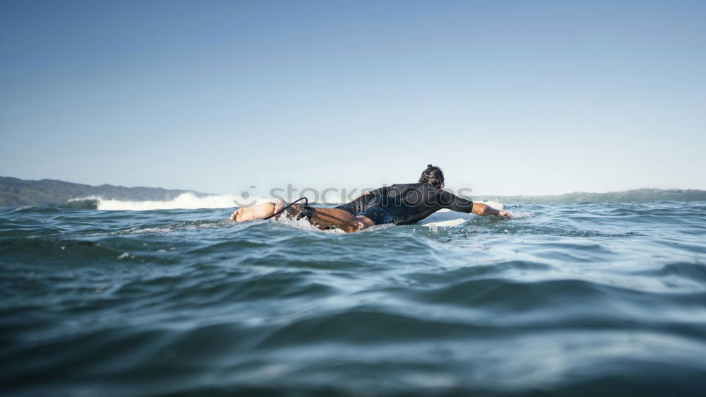 Similar – Image, Stock Photo Man in wetsuit swimming in ocean