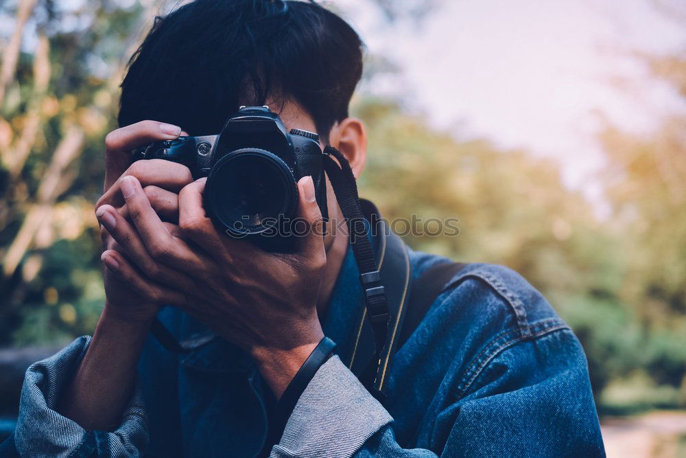 Similar – Photographer aiming with vintage camera