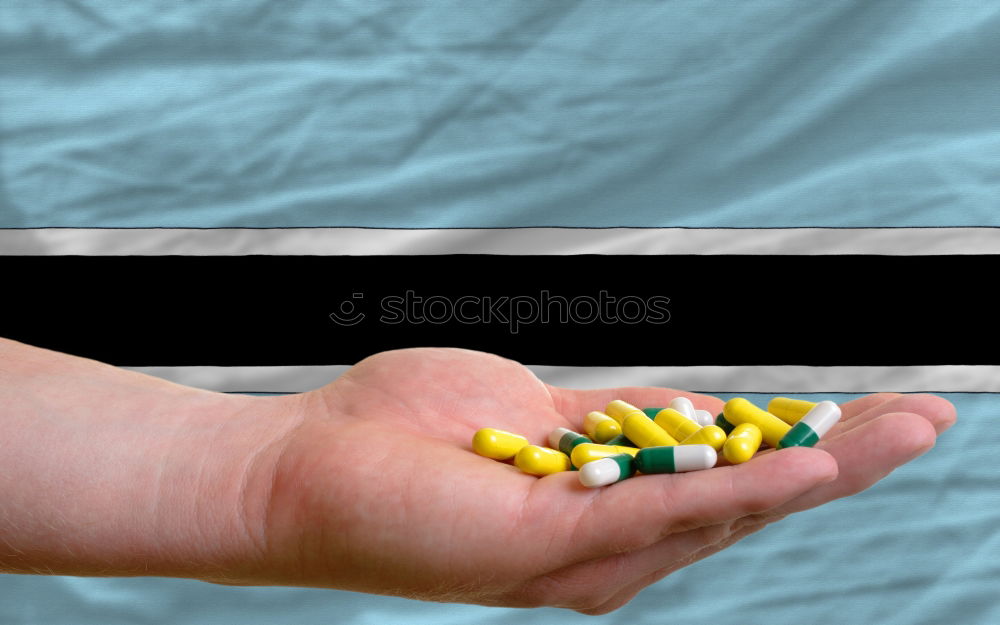 Similar – A hand in which several different colored tablets are lying; addiction problems, drug abuse, suicide