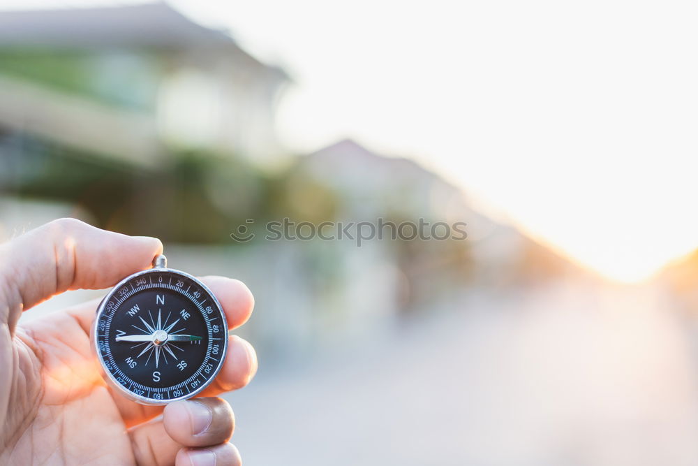 Similar – Image, Stock Photo Hand with compass at mountain road at blue sky