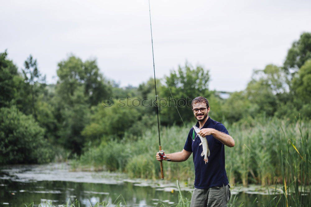 Similar – Fisherman caught a fish