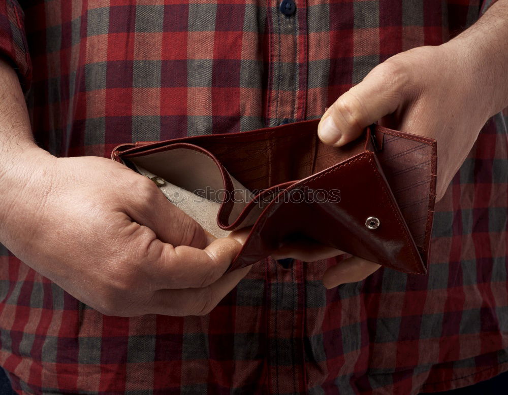 Similar – two female hands hold brown leather open empty wallet for cash