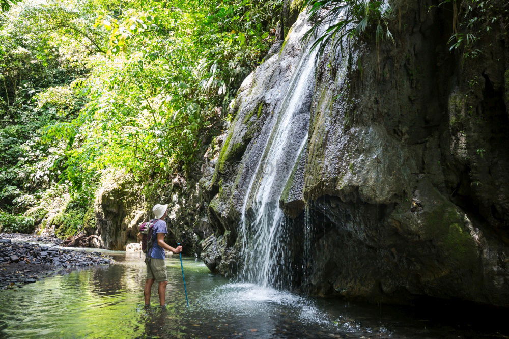 Similar – young woman standing in front of tropical waterfall