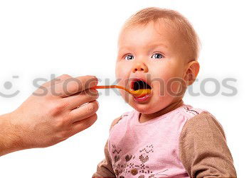 Similar – Daddy feeding toddler a spoonful of baby food