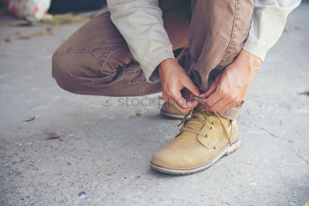 Similar – Blue jeans, boots with wooden smoking pipe