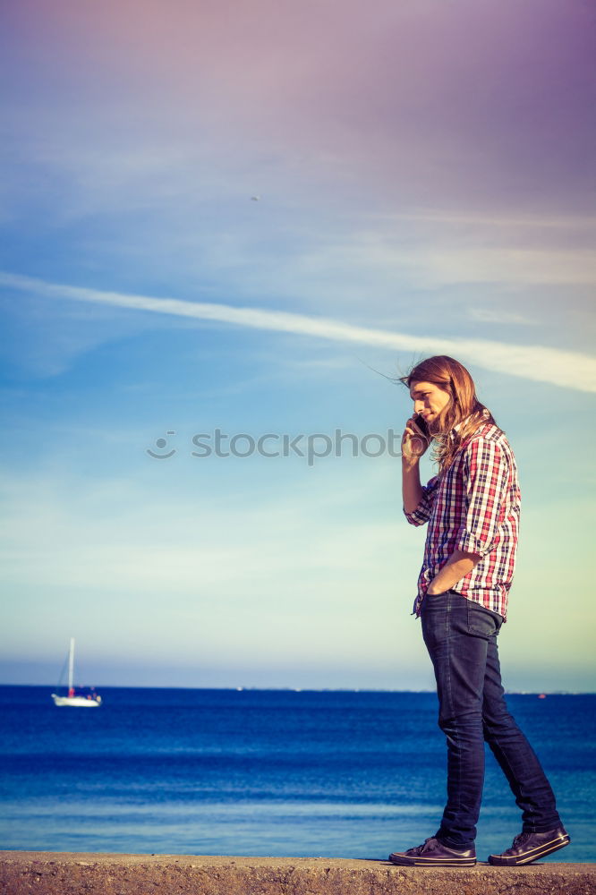 Similar – Image, Stock Photo Tourist sits on a bench on the beach