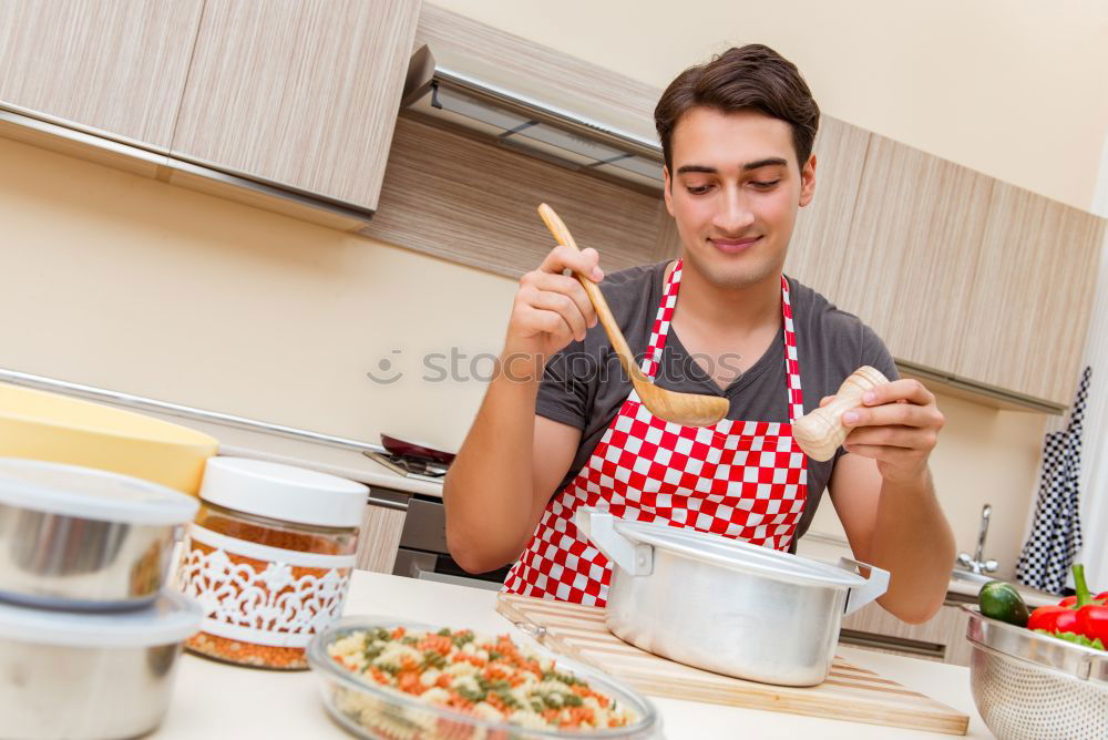 Similar – Young couple cooking. Man and woman in their kitchen