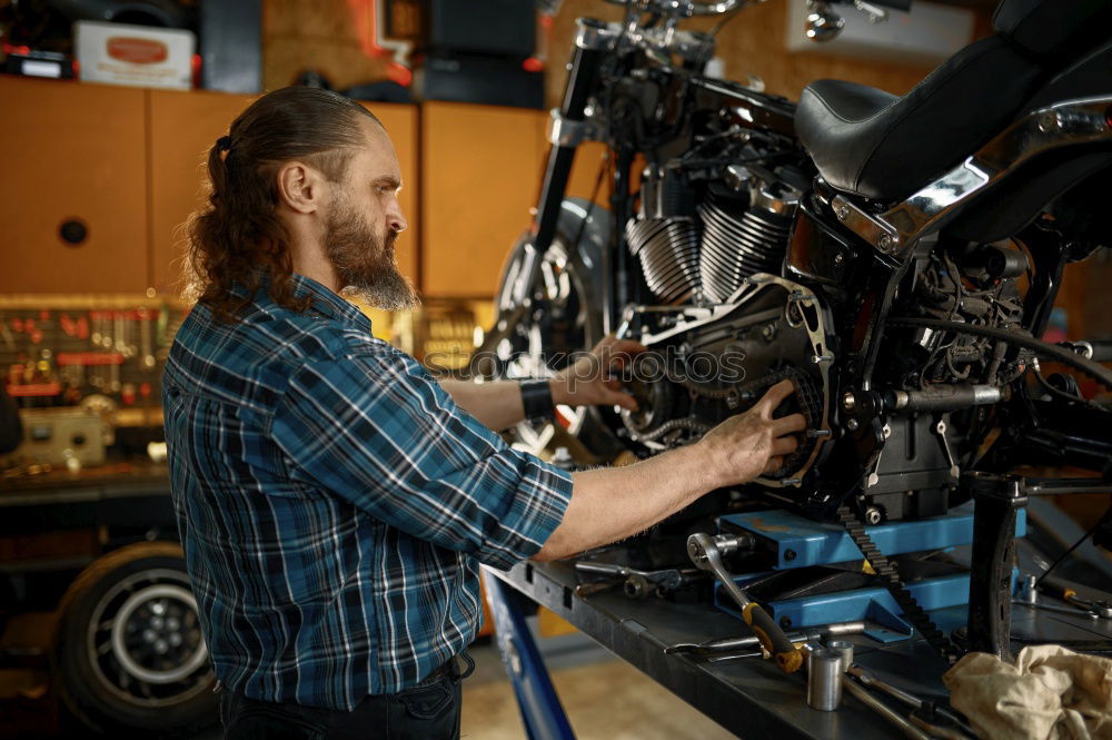 Similar – Image, Stock Photo Mechanic checking motorcycle