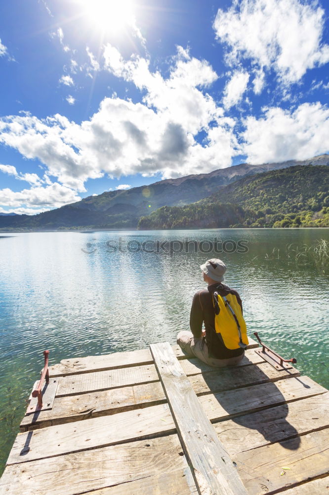 Similar – Image, Stock Photo Little boy on a dock sitting on his back looking to the ocean