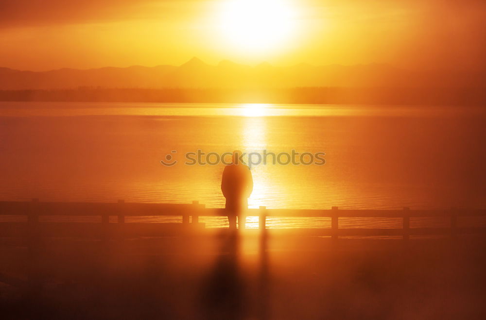 Image, Stock Photo The silhouette of man sitting alone at the beach