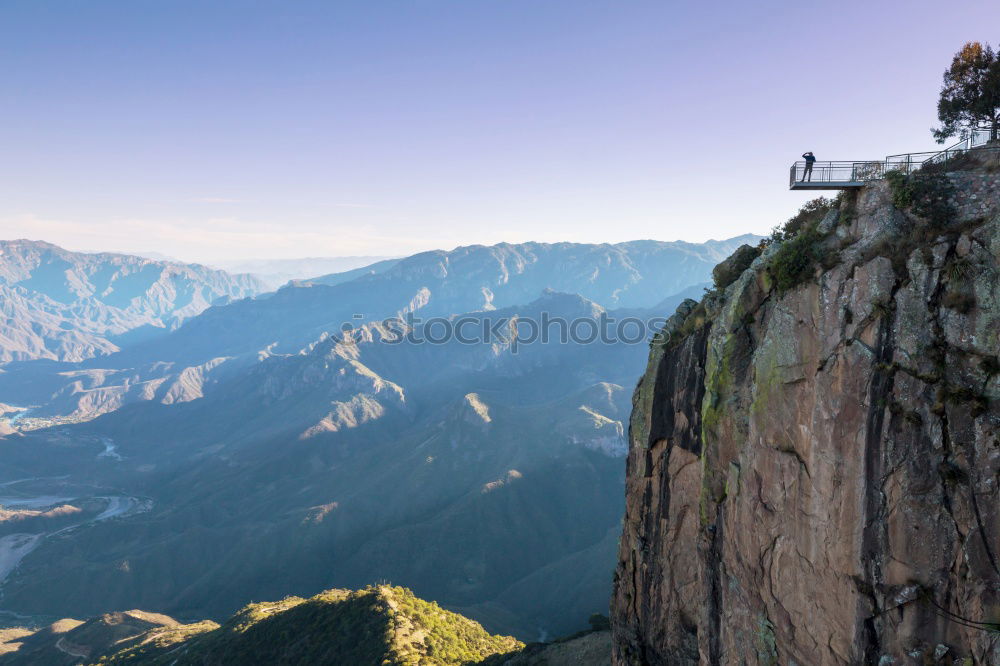 Similar – Team of climbers reaching the summit.