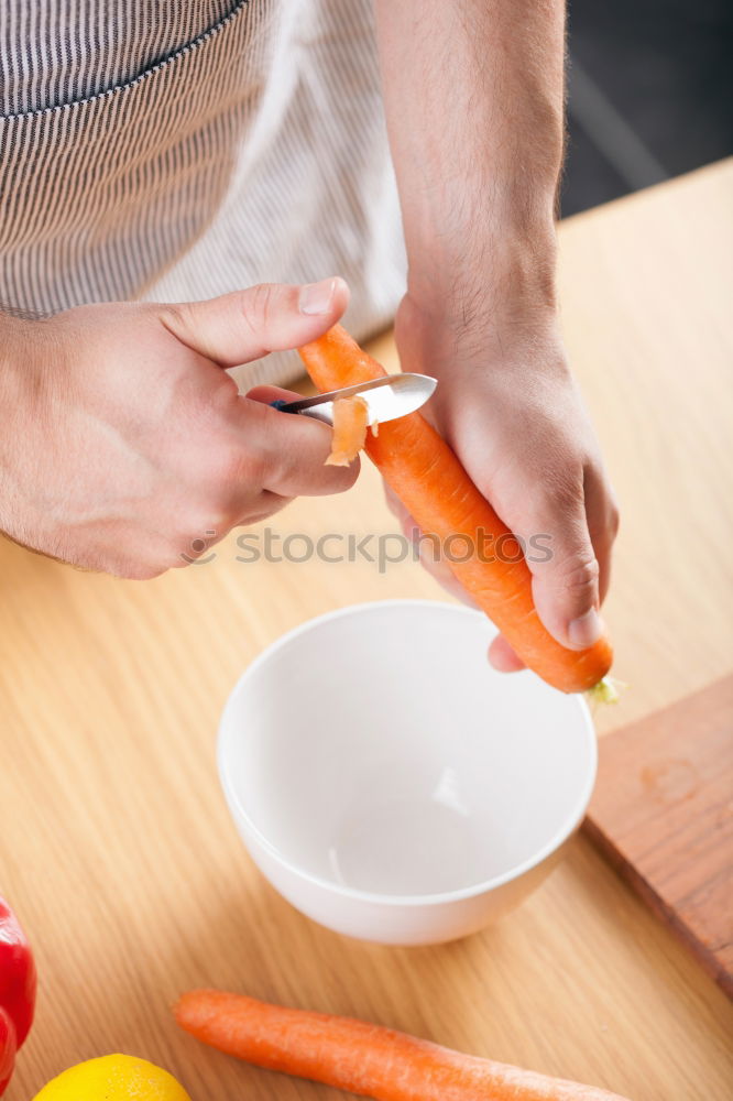 Similar – process of cutting slices of carrot on a kitchen board