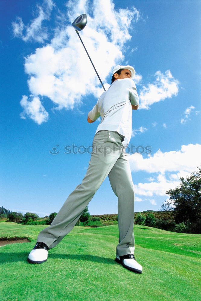 Similar – Golfer performs a golf shot from the fairway