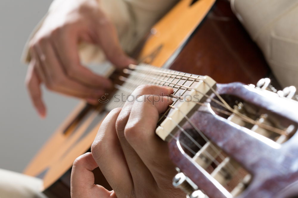 Similar – Image, Stock Photo Man playing guitar and composing music at home near a bright window on a sunny day. Casual musician sitting on the floor playing the guitar.