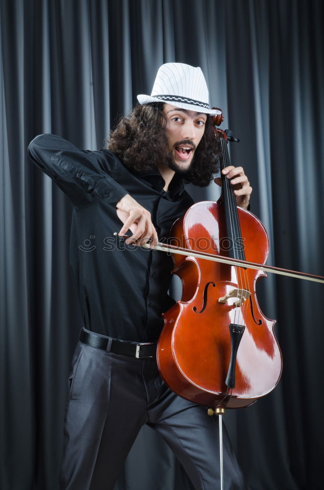 Similar – Image, Stock Photo Guitarist sitting on guitar combo