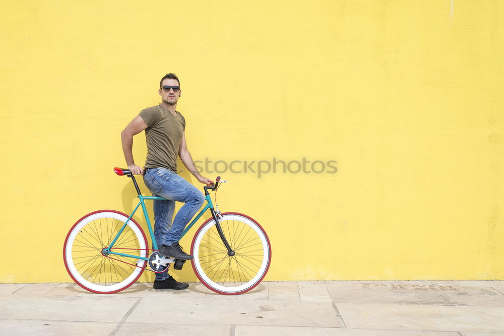 Similar – Side view of a young hipster man with a fixed bike