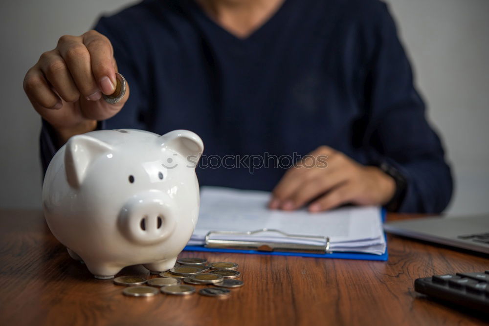 Similar – Unhappy man angry at his piggy bank