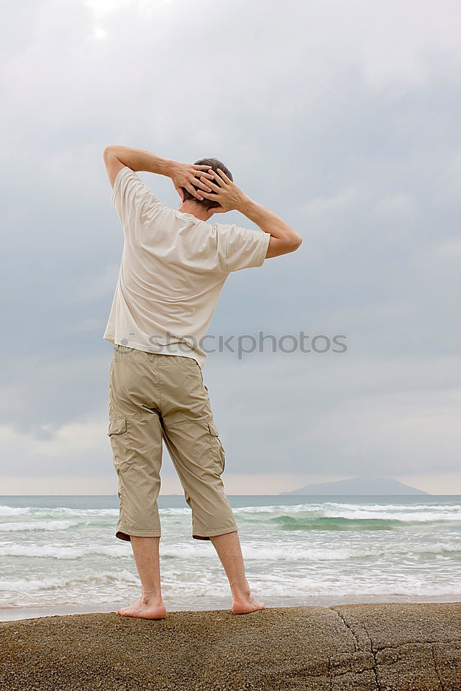 Similar – Rear view of a female senior citizen and two seniors sitting on gravel and looking out to sea