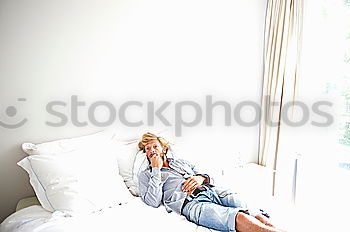 Similar – Young woman sitting in windowsill in sunlit kitchen smiling at camera