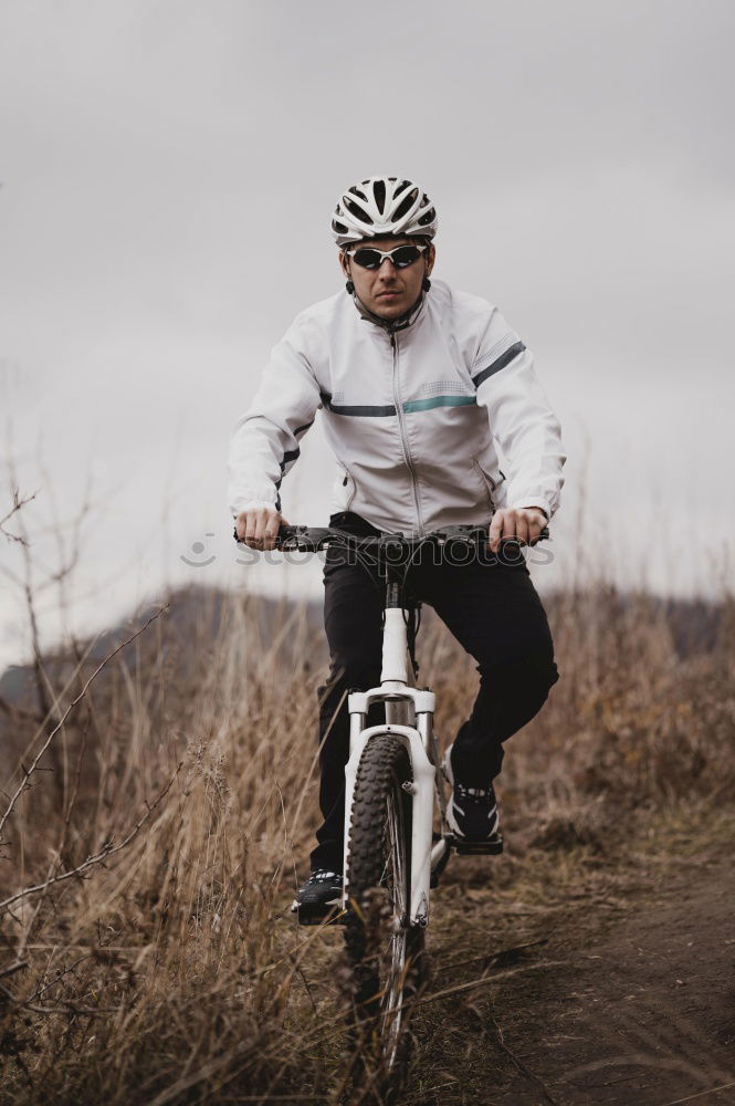 Similar – Cyclist Riding a bike at sunset. Sports